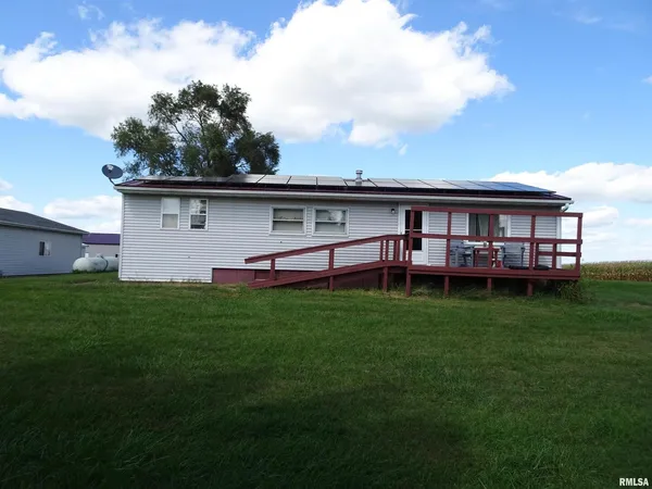 a view of a house with a backyard