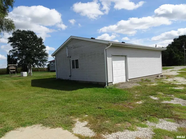 a backyard of a house with plants and a garden