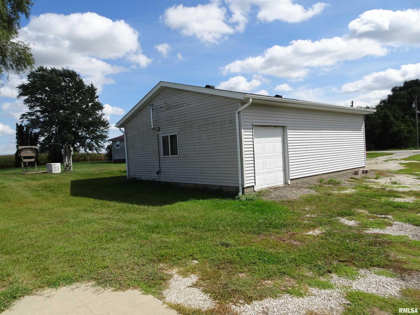 26004-2000 County Road North Annawan, IL 61234 - Photo 12 of 17 a backyard of a house with plants and a garden