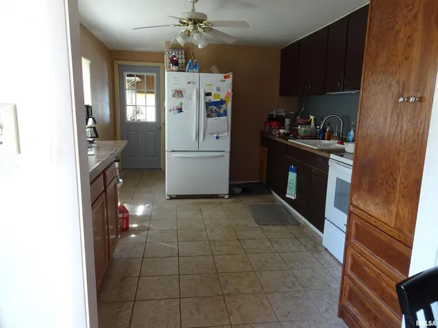 a kitchen with stainless steel appliances a refrigerator and a stove top oven