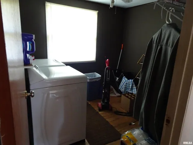 a room with water heater and a air conditioner vent