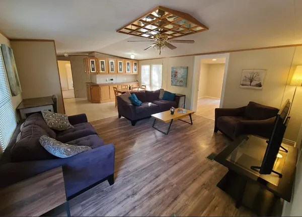 a living room with furniture and a chandelier