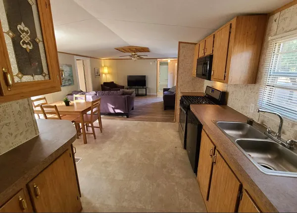 a view of a house with a tree in the background