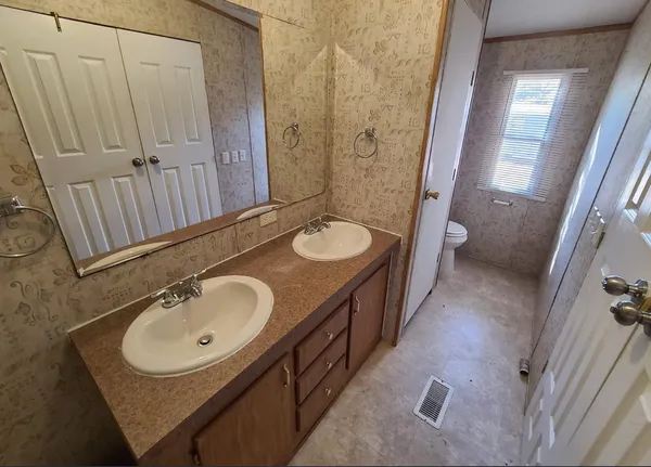 a view of a dining room with furniture and a window