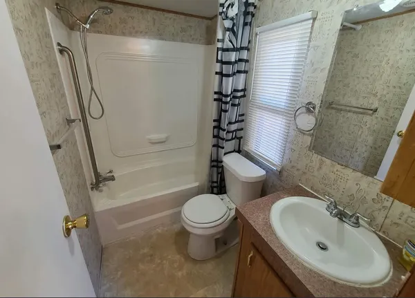 a bedroom with a bed table and chair