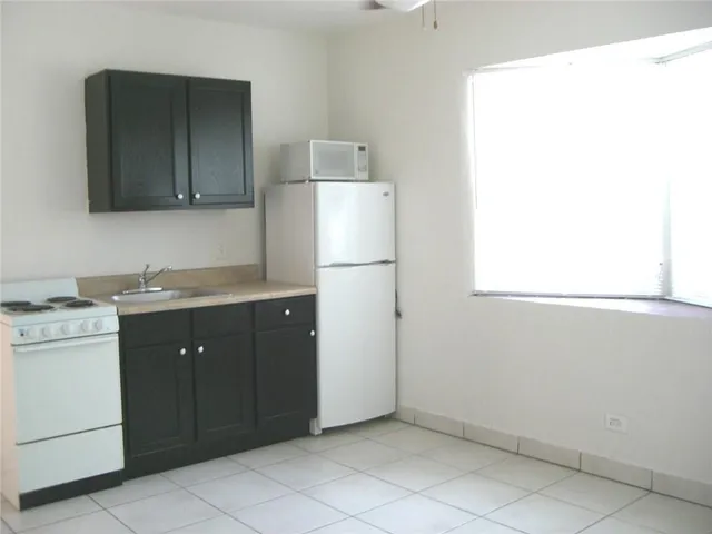 a kitchen with a sink and a refrigerator