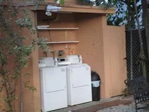 a white house with a sink and wooden floor