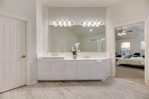 a bathroom with a sink mirror and vanity