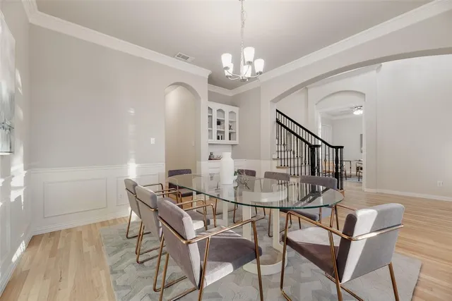 a view of a dining room with furniture and a chandelier