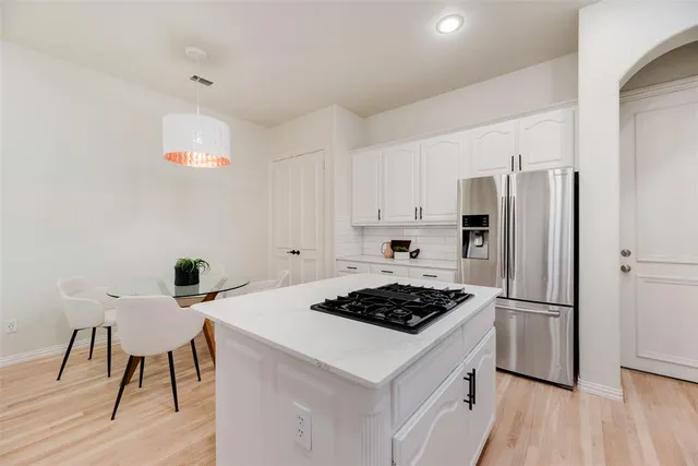 a kitchen with a appliances a stove a sink and a refrigerator
