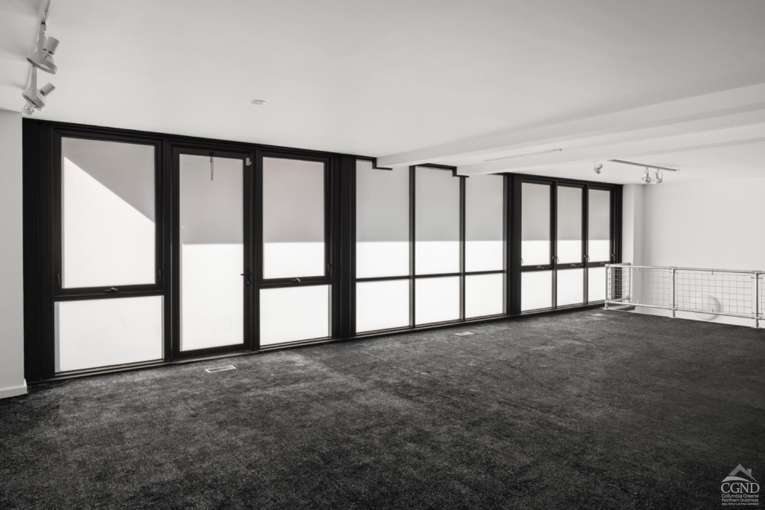 355 Warren Street Hudson, NY 12534 - Photo 14 of 16 a view of an empty room with a window