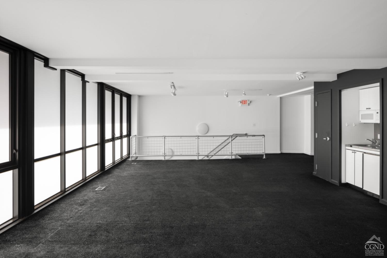 355 Warren Street Hudson, NY 12534 - Photo 6 of 16 a view of an empty room with chandelier fan and wooden floor