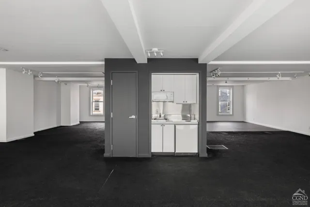 a big room with closet and wooden floor