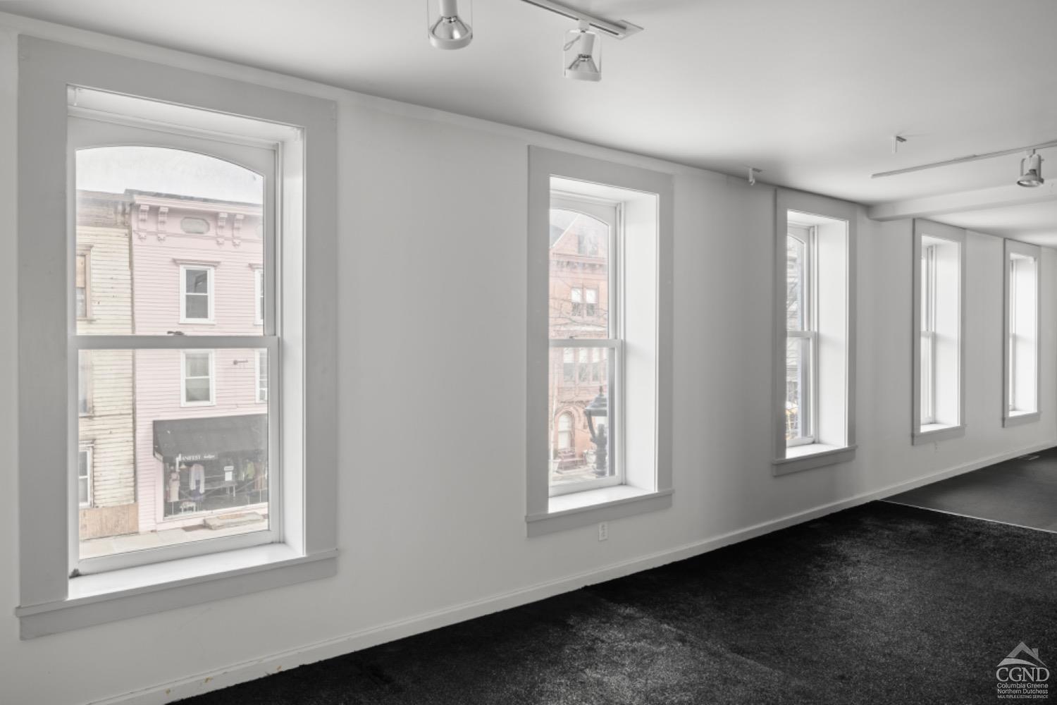 355 Warren Street Hudson, NY 12534 - Photo 10 of 16 an empty room with windows