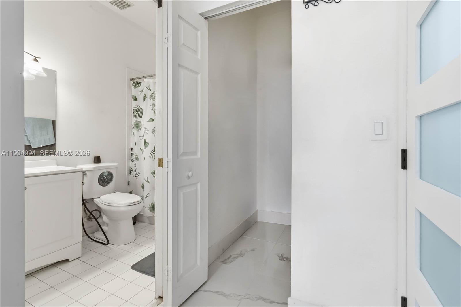 64 Southwest 15th Terrace Homestead, FL 33030 - Photo 11 of 26 a bathroom with a granite countertop toilet and a shower