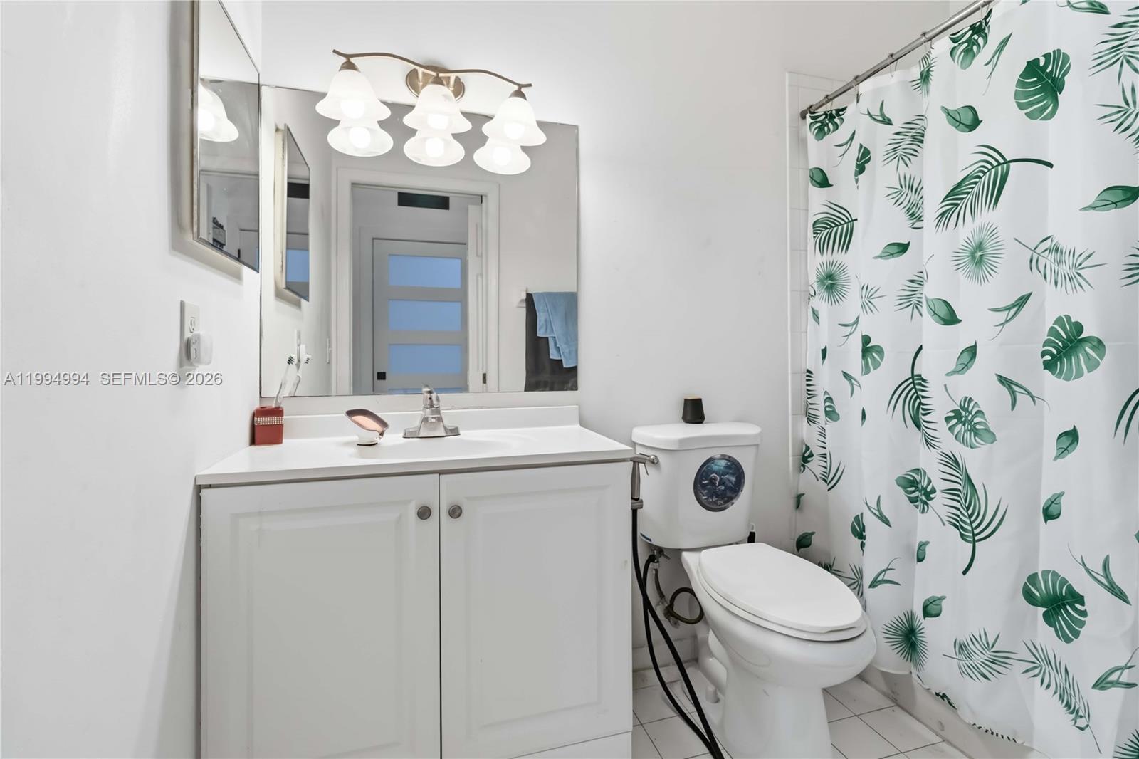 64 Southwest 15th Terrace Homestead, FL 33030 - Photo 12 of 26 a bathroom with a toilet sink vanity granite and mirror