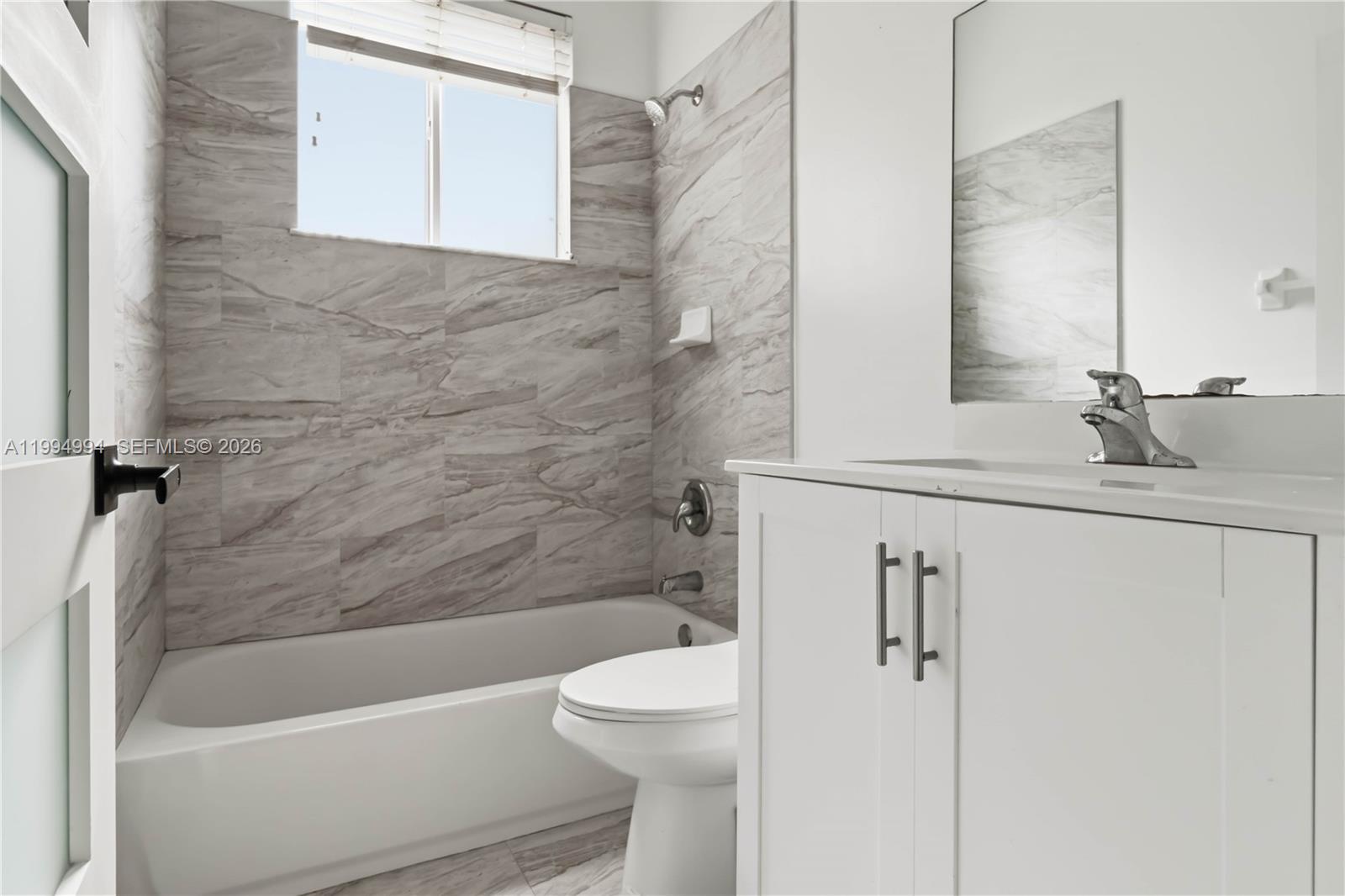 64 Southwest 15th Terrace Homestead, FL 33030 - Photo 16 of 26 a bathroom with a granite countertop sink toilet and shower
