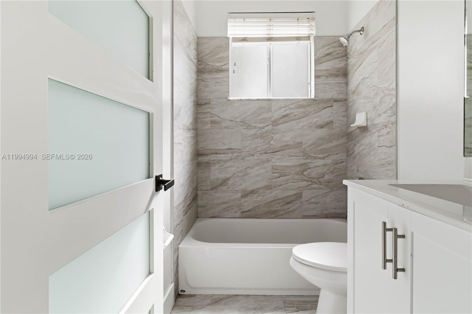 64 Southwest 15th Terrace Homestead, FL 33030 - Photo 17 of 26 a bathroom with a sink a toilet and bathtub