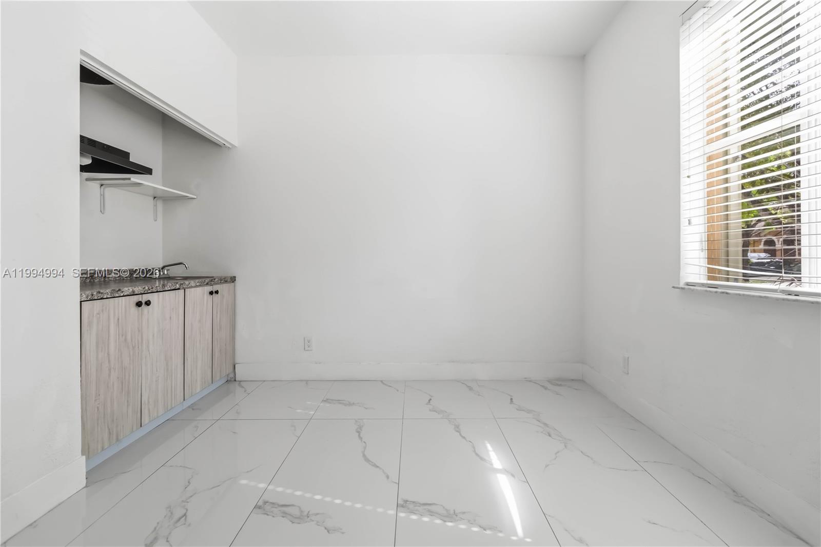 64 Southwest 15th Terrace Homestead, FL 33030 - Photo 19 of 26 an empty room with a empty space and windows