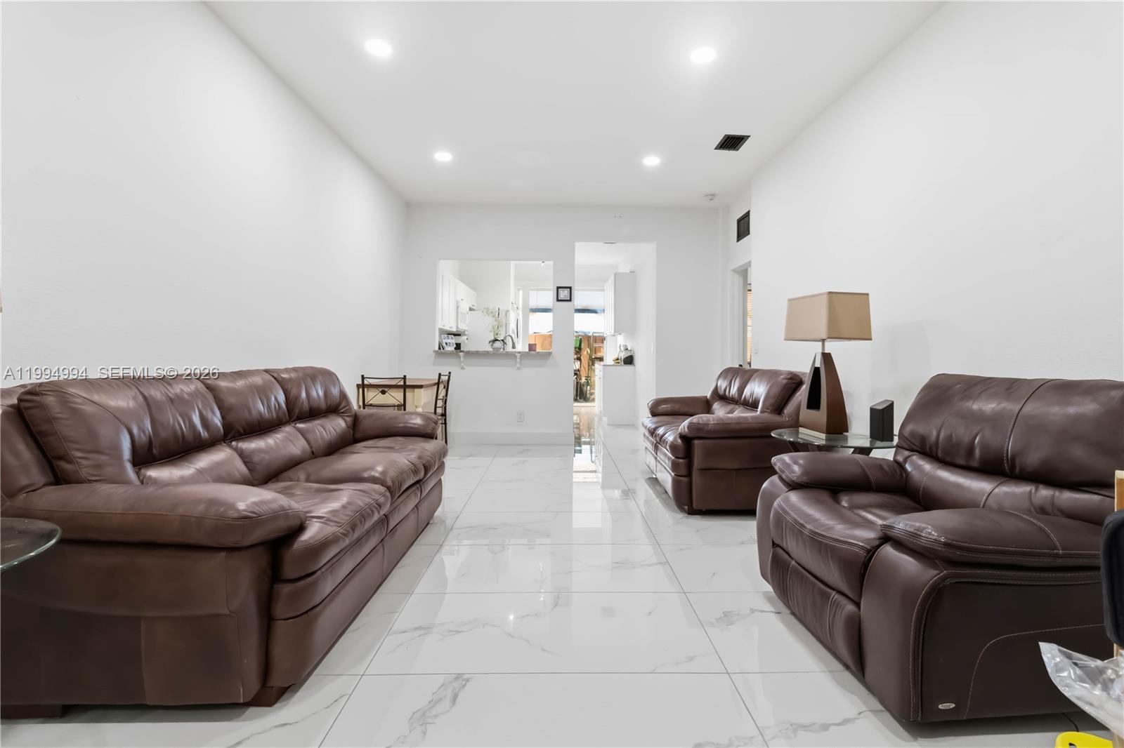 64 Southwest 15th Terrace Homestead, FL 33030 - Photo 2 of 26 a living room with furniture and a couch