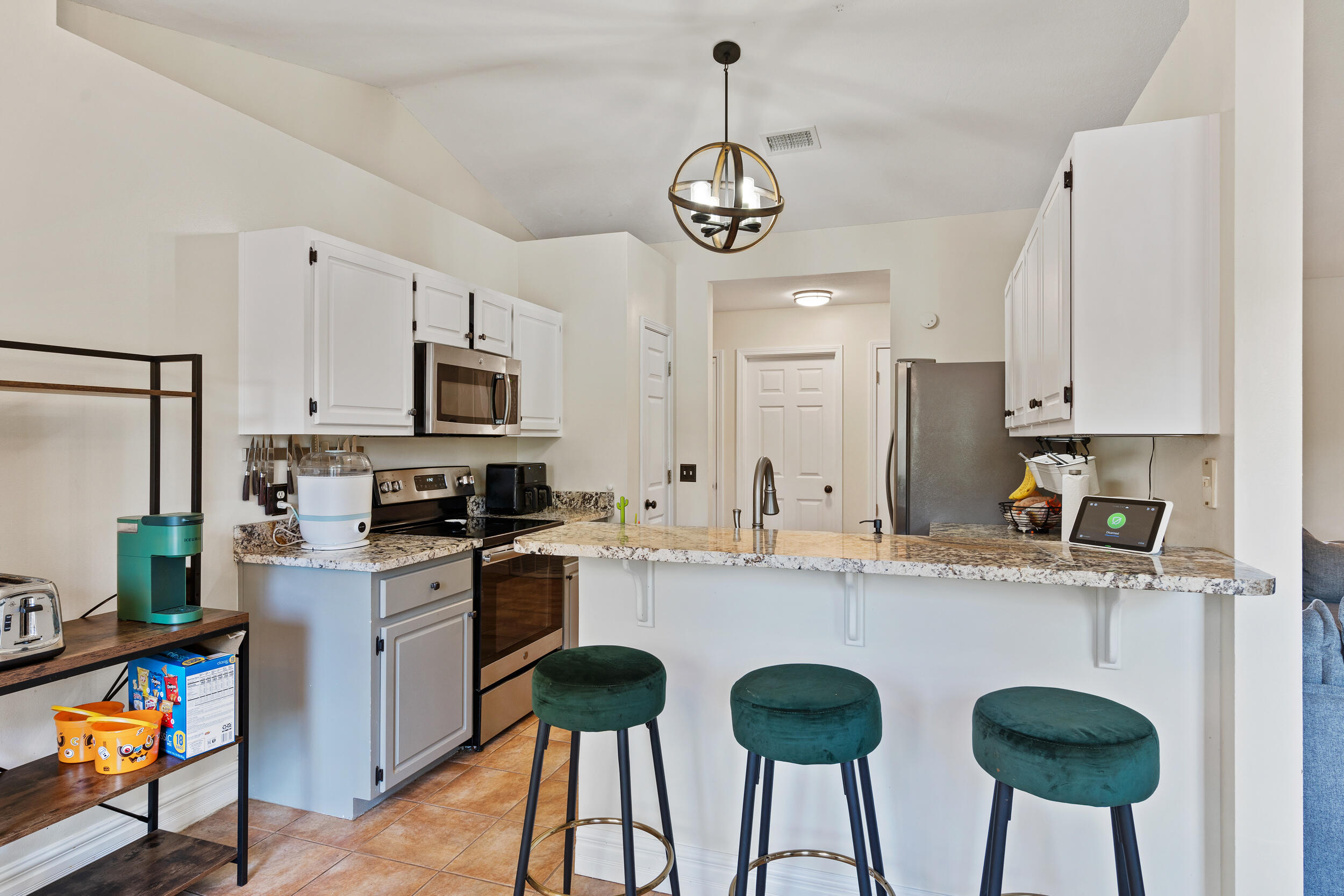 2852 Atoka Trail Crestview, FL 32539 - Photo 12 of 43 a kitchen with stainless steel appliances granite countertop a sink a stove a refrigerator and island with wooden floor