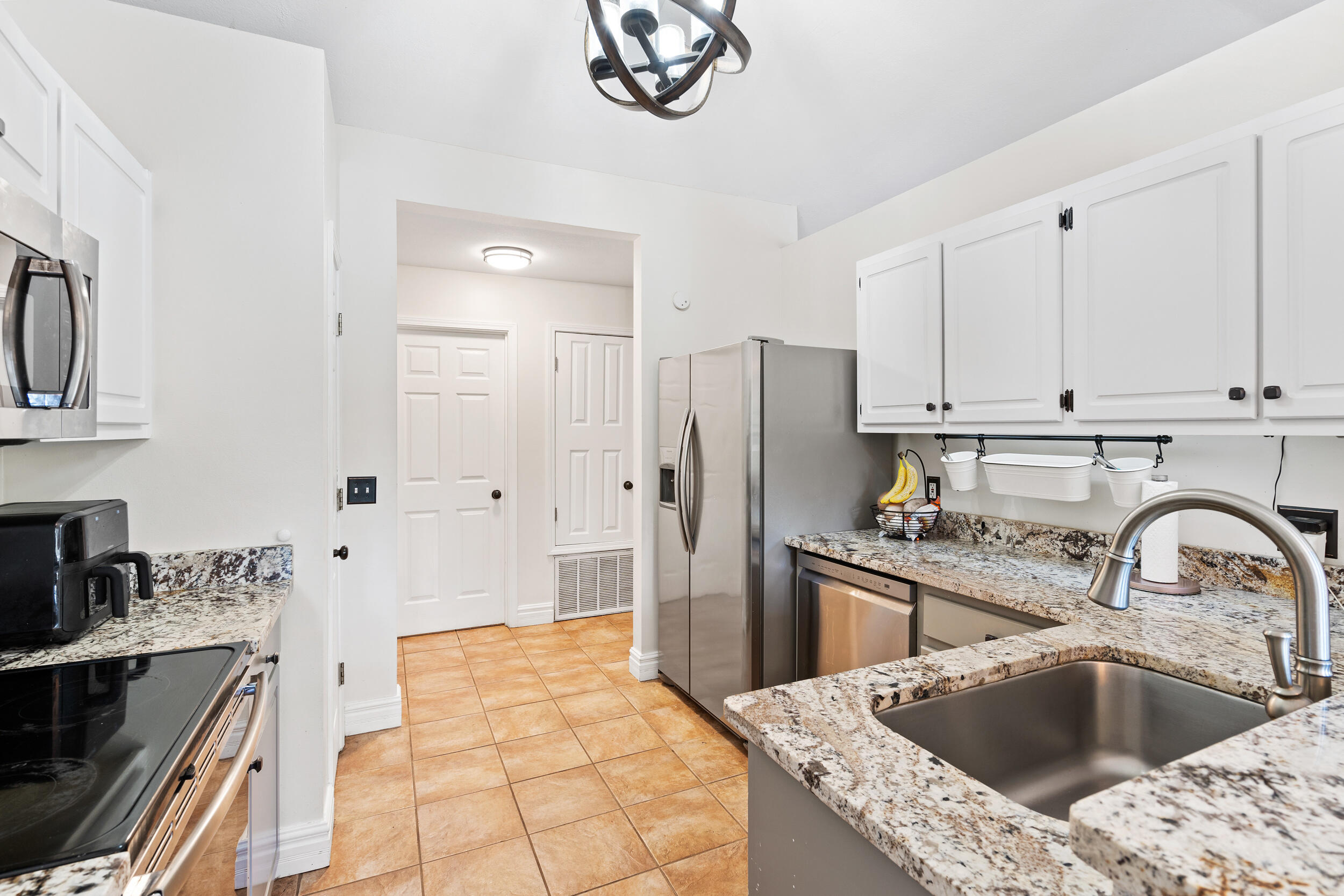 2852 Atoka Trail Crestview, FL 32539 - Photo 13 of 43 a kitchen with stainless steel appliances a refrigerator sink and cabinets