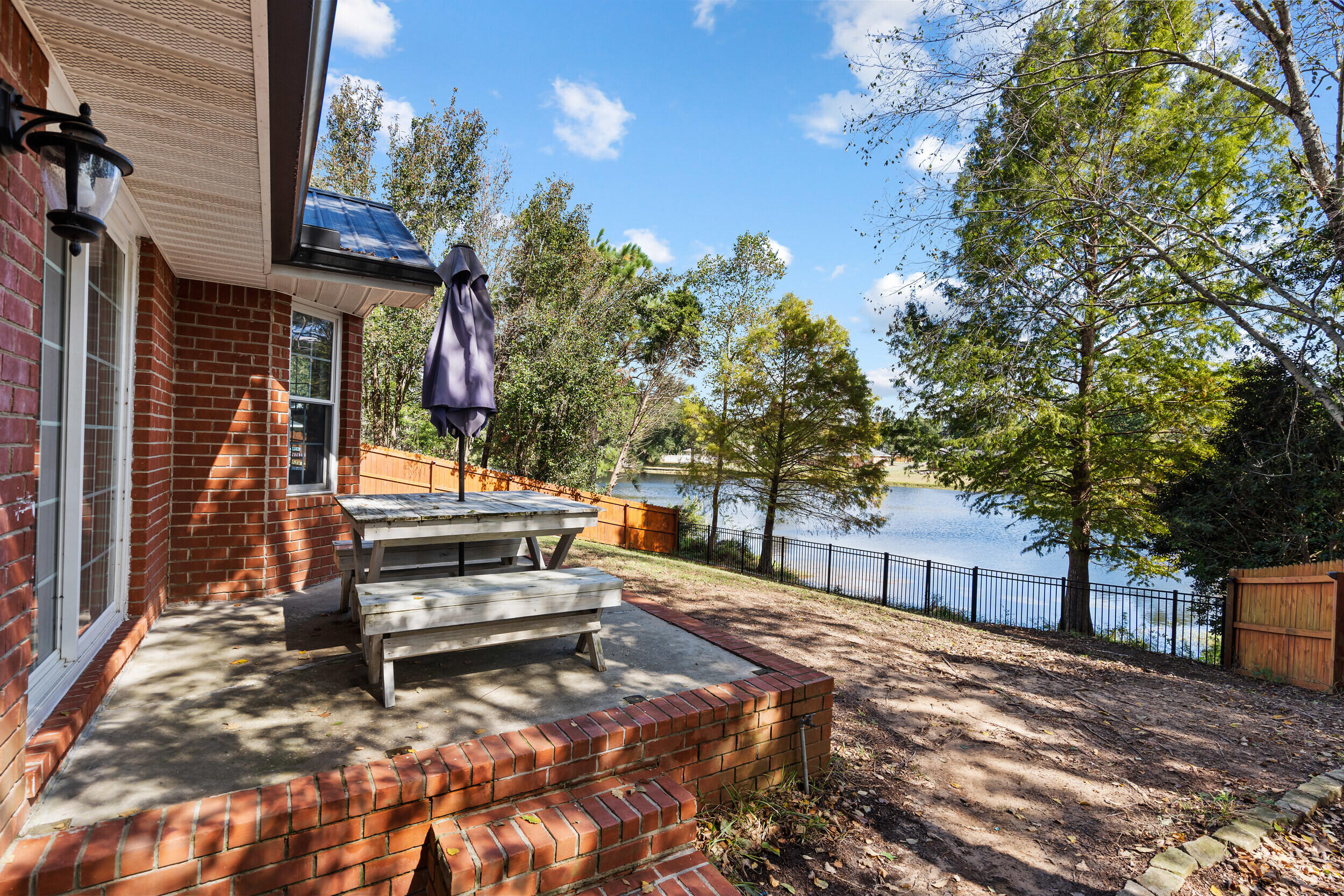 2852 Atoka Trail Crestview, FL 32539 - Photo 2 of 43 a view of a bench in a backyard of house