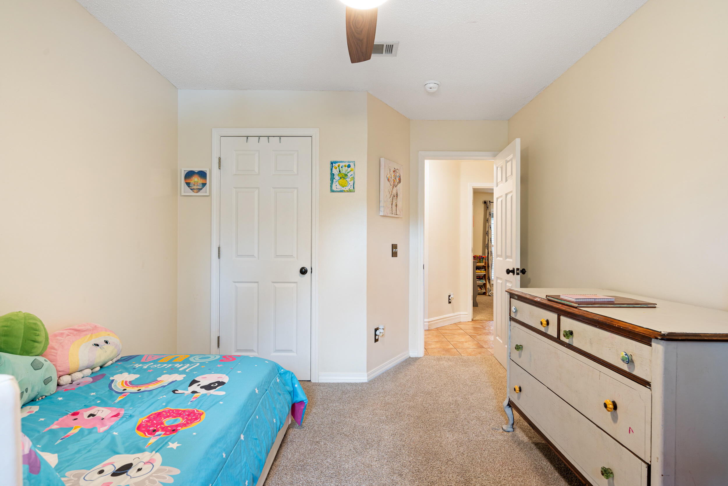 2852 Atoka Trail Crestview, FL 32539 - Photo 27 of 43 a bedroom with a bed and a dresser in it