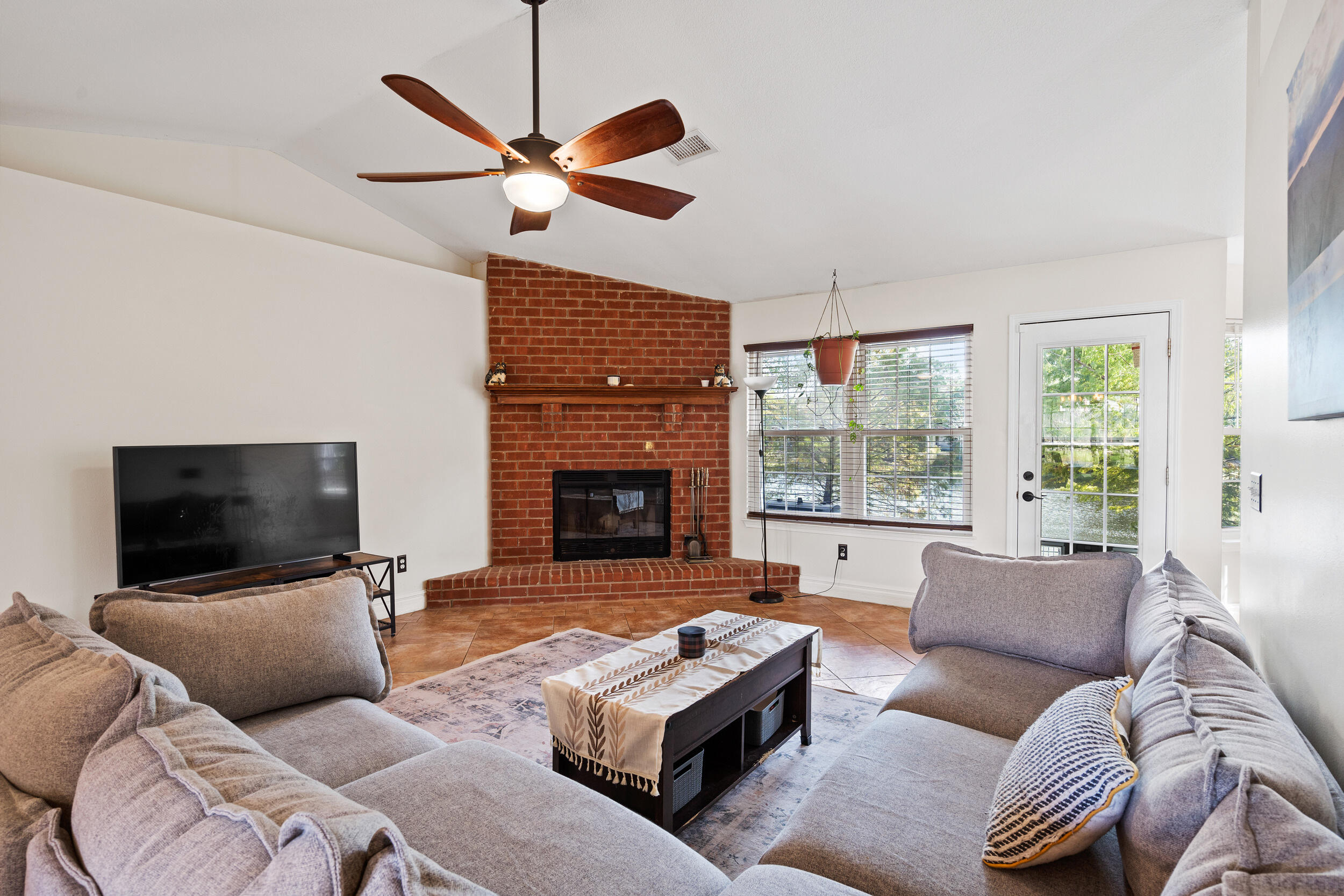 2852 Atoka Trail Crestview, FL 32539 - Photo 6 of 43 a living room with furniture a flat screen tv and a fireplace