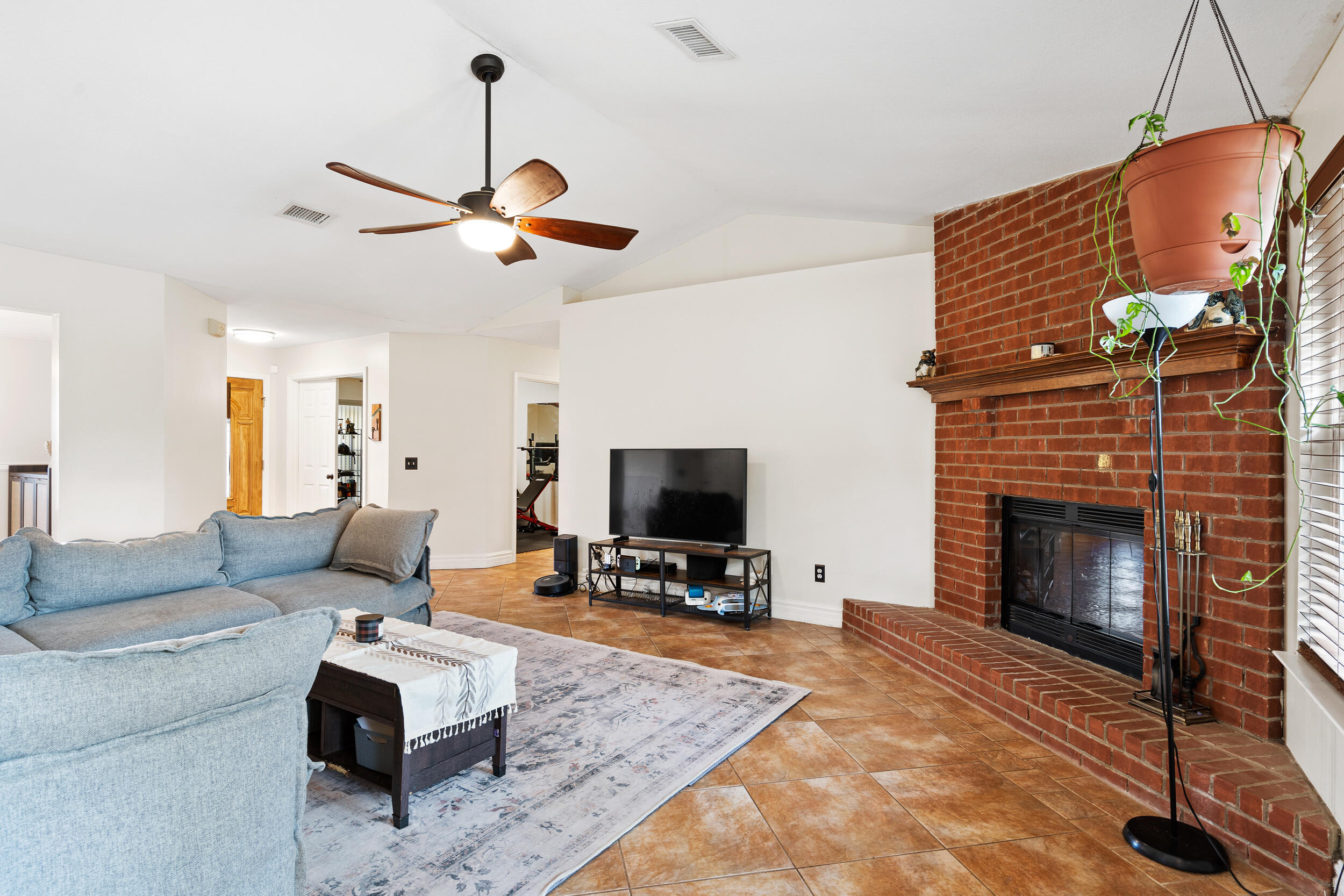 2852 Atoka Trail Crestview, FL 32539 - Photo 8 of 43 a living room with furniture flat screen tv and a fireplace
