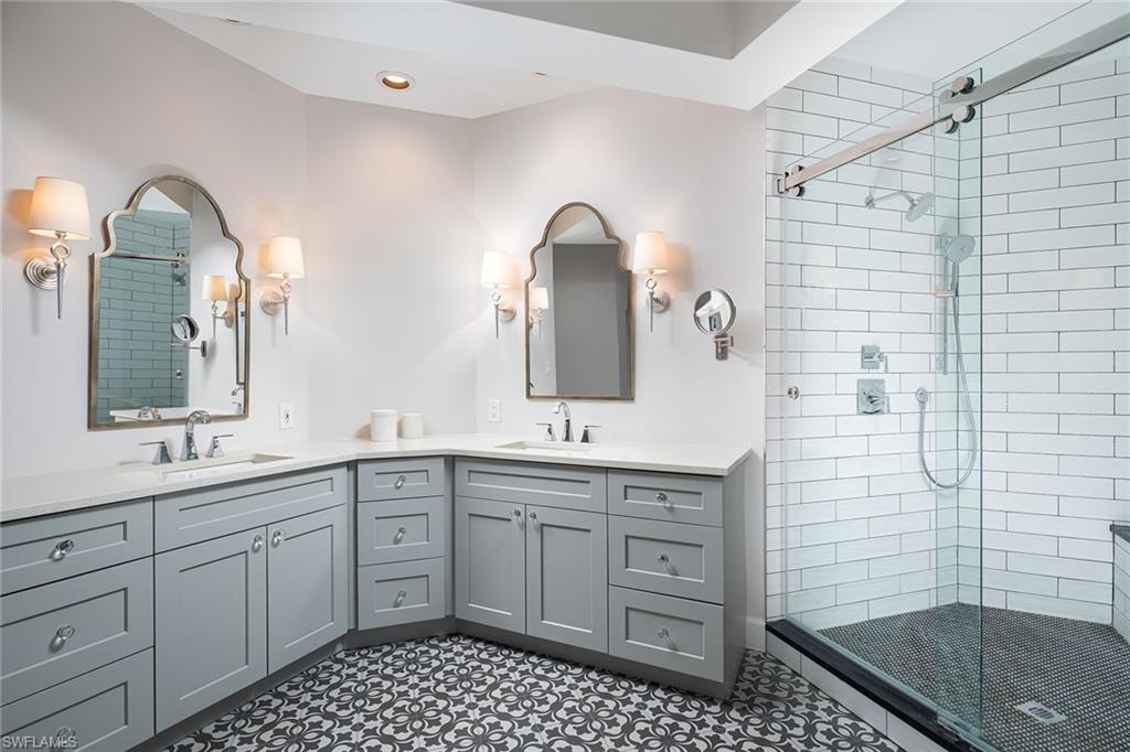 142 Colonade Circle Naples, FL 34103 - Photo 15 of 30 a bathroom with a double vanity sink mirror and