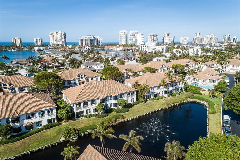 142 Colonade Circle Naples, FL 34103 - Photo 25 of 30 an aerial view of a city with lots of residential buildings ocean and mountain view in back