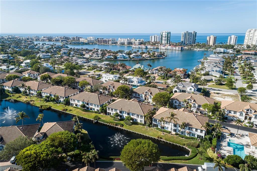 142 Colonade Circle Naples, FL 34103 - Photo 26 of 30 an aerial view of a city with lots of residential buildings ocean and mountain view in back
