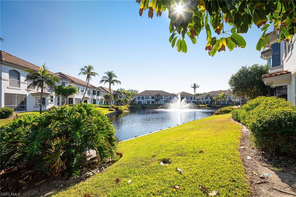 142 Colonade Circle Naples, FL 34103 - Photo 9 of 30 a view of a swimming pool with a yard