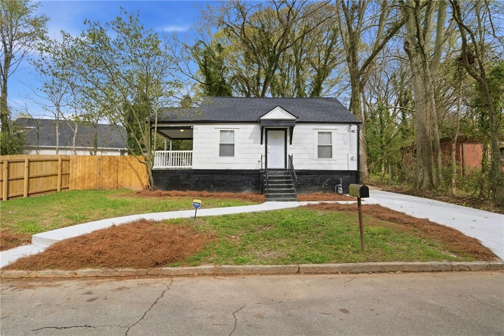 1458 Olive Street Southwest Atlanta, GA 30310 - Photo 1 of 38 a front view of a house with a yard