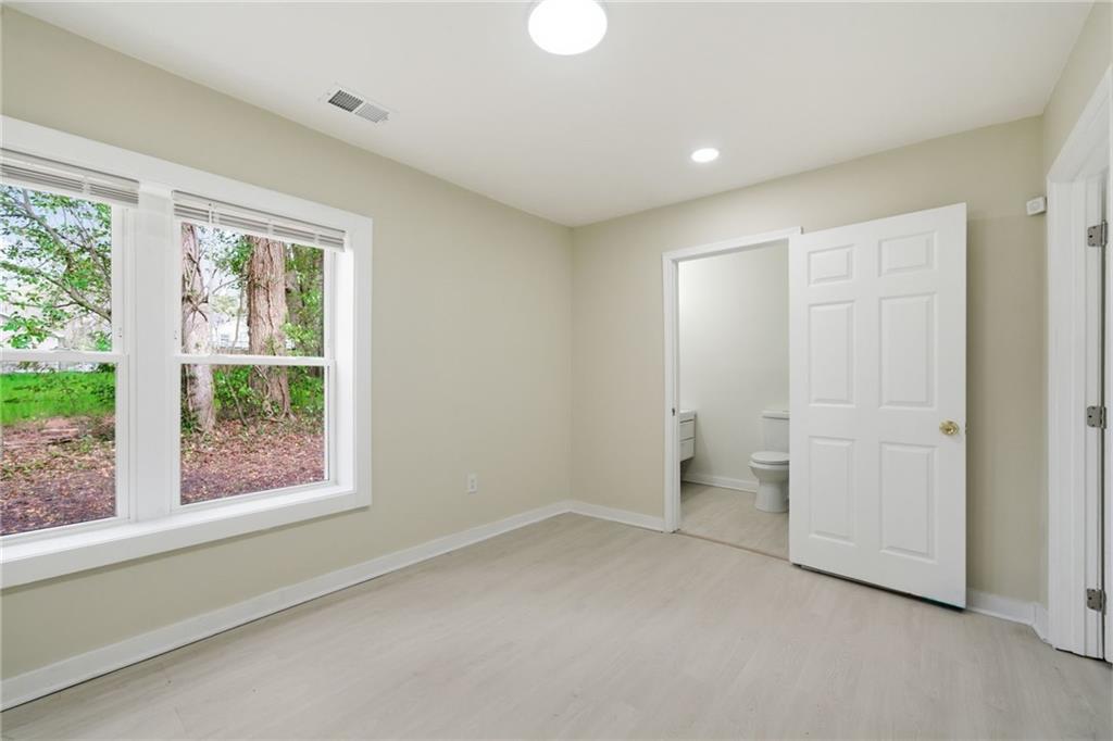 1458 Olive Street Southwest Atlanta, GA 30310 - Photo 18 of 38 an empty room with a window and a toilet