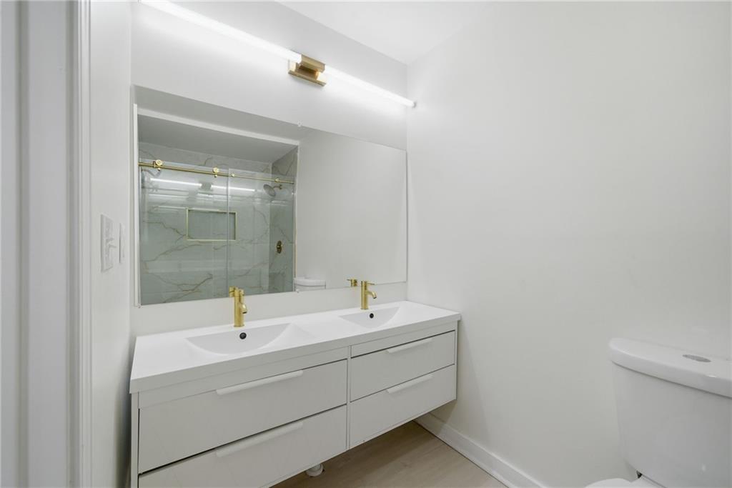 1458 Olive Street Southwest Atlanta, GA 30310 - Photo 19 of 38 a bathroom with a sink a mirror and a bathtub
