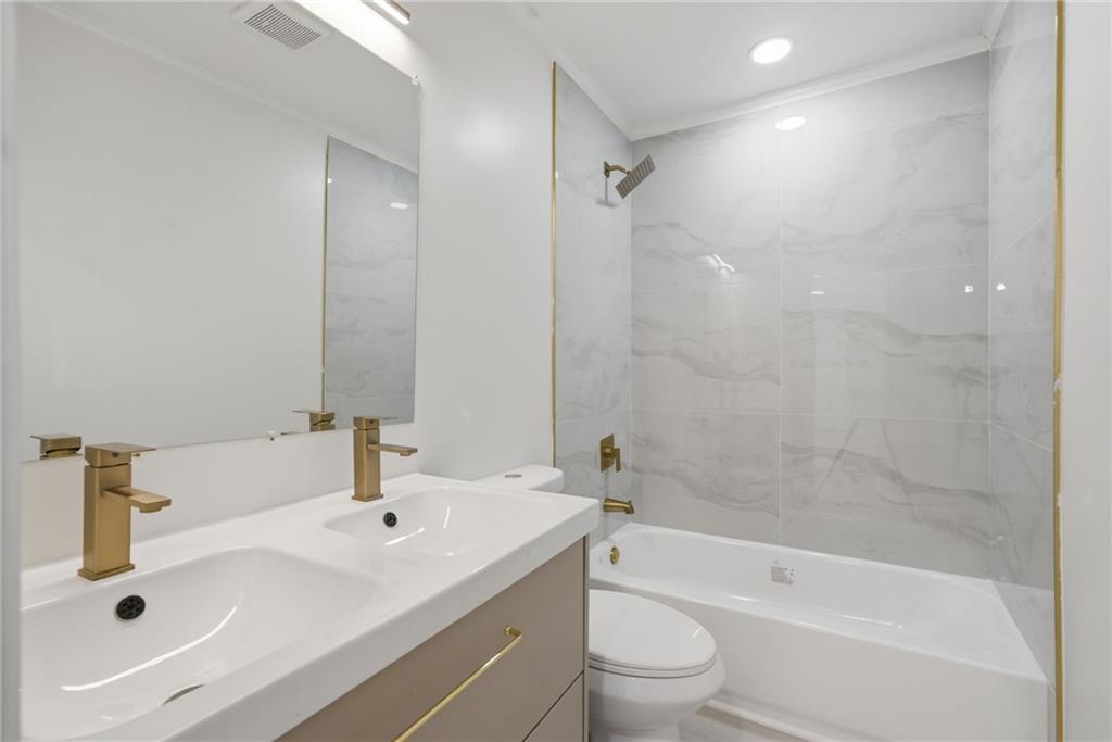 1458 Olive Street Southwest Atlanta, GA 30310 - Photo 23 of 38 a bathroom with a sink a toilet and shower