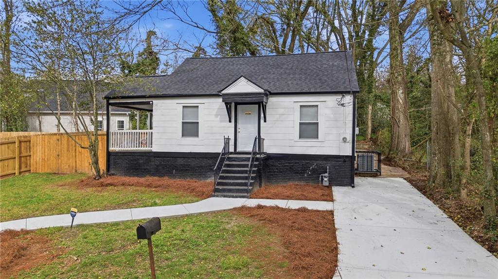 1458 Olive Street Southwest Atlanta, GA 30310 - Photo 32 of 38 a front view of a house with a yard