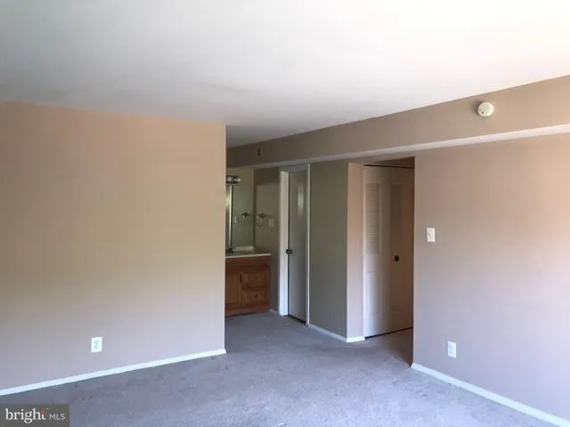 an empty room with closet area