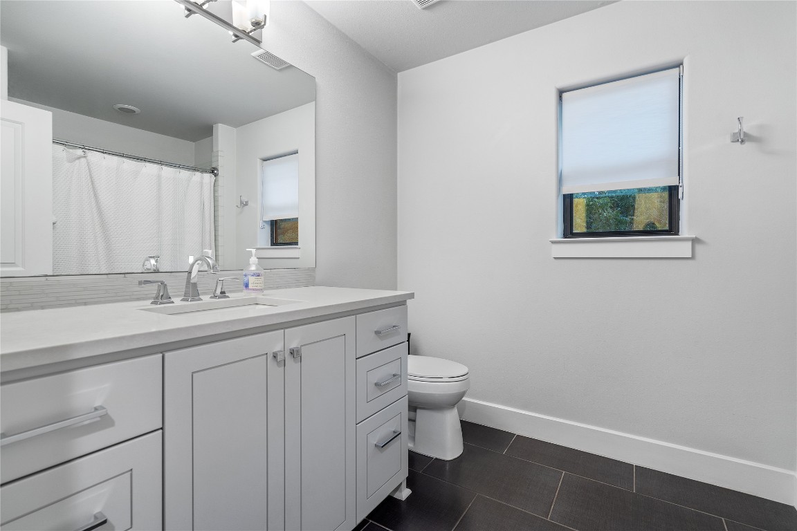 2811 Del Curto Road, Unit A Austin, TX 78704 - Photo 20 of 40 Guest bathroom featuring vanity, a shower with shower curtain, and tile flooring