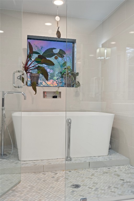 2811 Del Curto Road, Unit A Austin, TX 78704 - Photo 24 of 40 Primary bath with a soaking tub, tile walls, and tile patterned floors