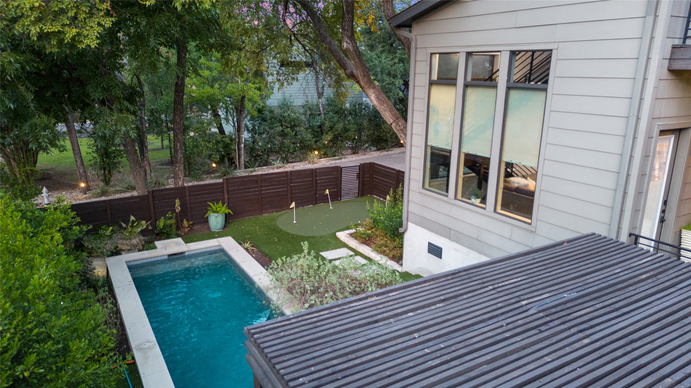 2811 Del Curto Road, Unit A Austin, TX 78704 - Photo 29 of 40 a view of a deck with couches chairs and wooden floor