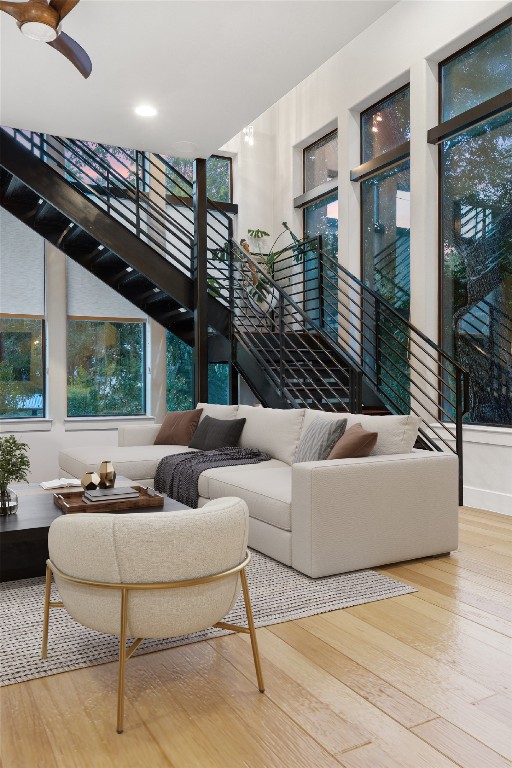 2811 Del Curto Road, Unit A Austin, TX 78704 - Photo 7 of 40 Living room featuring a towering ceiling, light wood-type flooring, and stairway