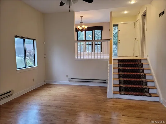 a view of an entryway with wooden floor