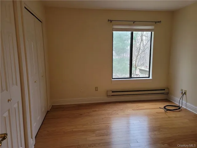 a view of a room with wooden floor and window