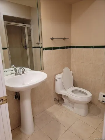 a bathroom with a sink mirror and toilet