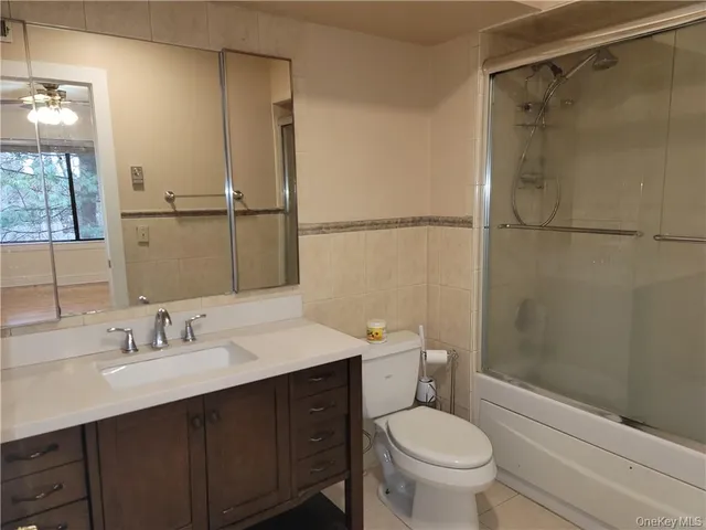 a bathroom with a sink toilet a mirror and shower