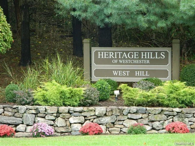 a view of a swimming pool with a bench and tables