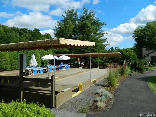 a front view of a house with a garden and yard